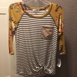 3/4 sleeve top. Black stripe body, floral sleeve